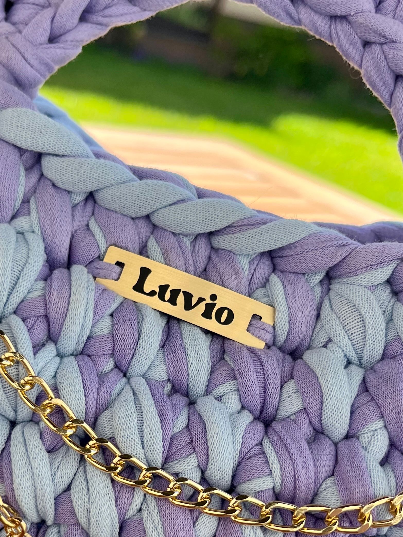 close-up of a premium handcrafted woven label on a folded linen garment, warm morning light, minimal
